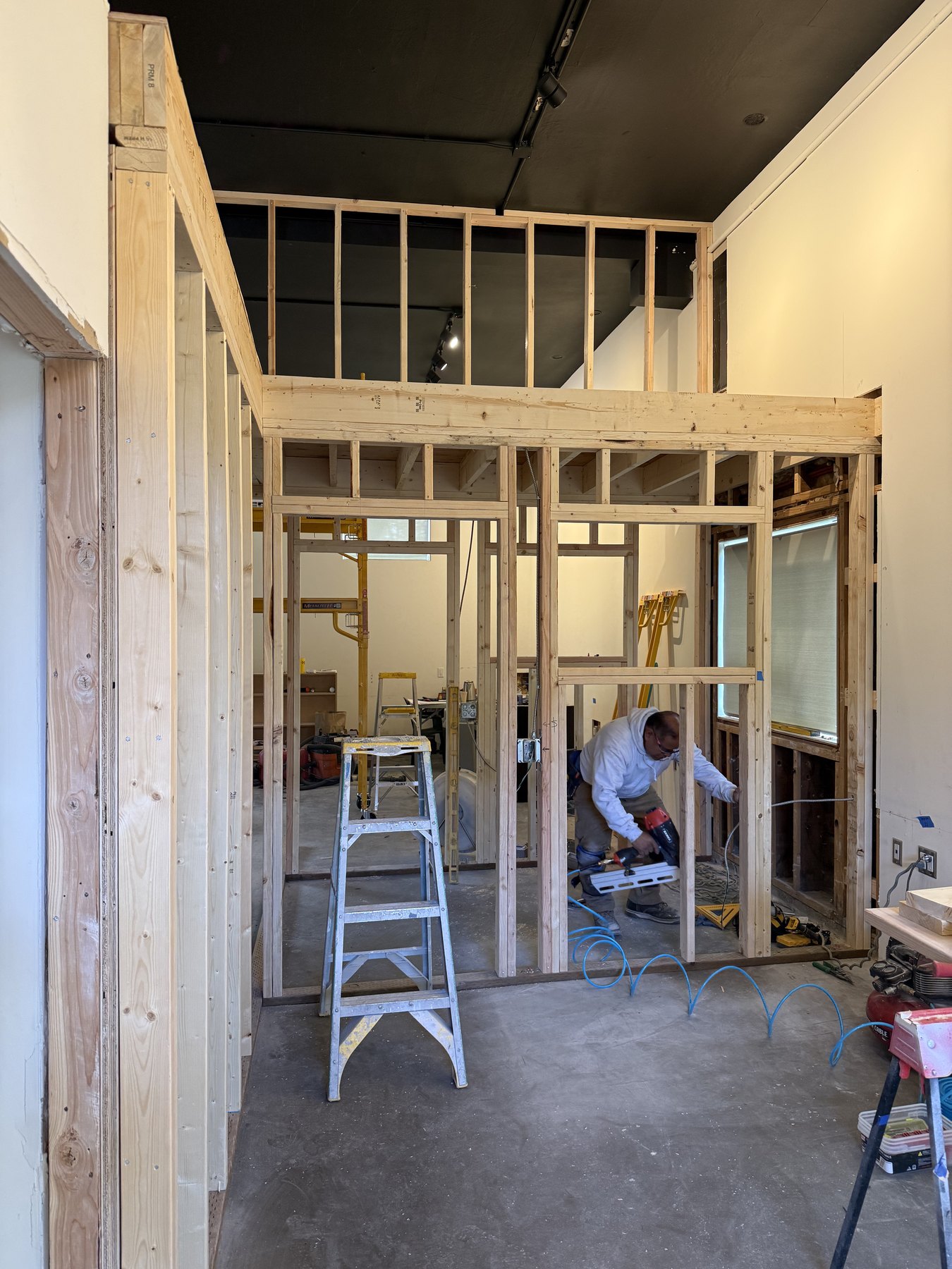 Commercial interior build-out with detailed framing and a high ceiling
